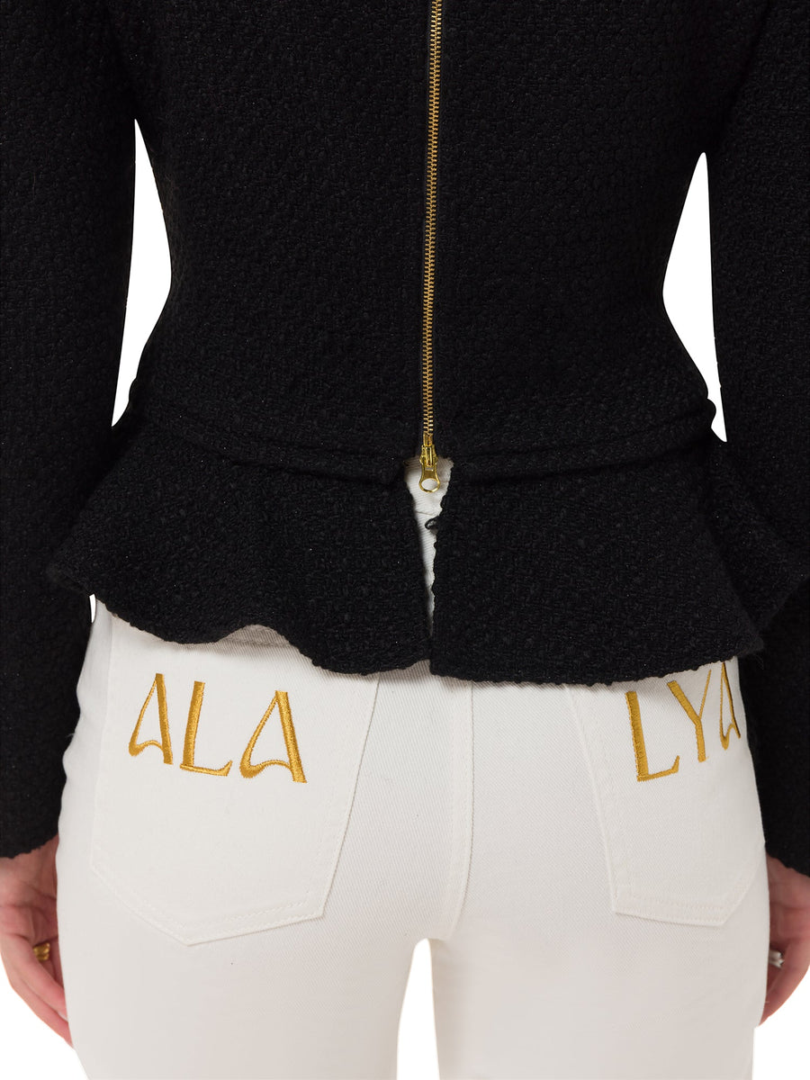 Back view of luxury sculpted black sweater with gold zip – ALALYA