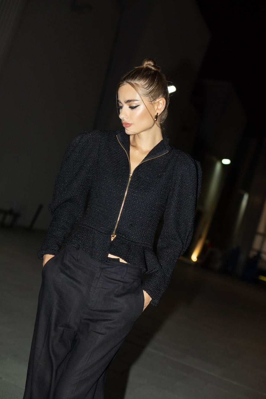 Evening look featuring black puff sleeve ALALYA top with high-waist trousers