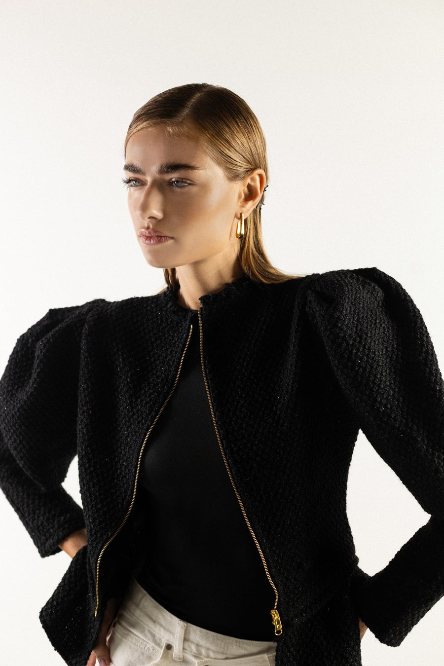 Sculptural puff sleeve black sweater styled for evening – ALALYA GCC.